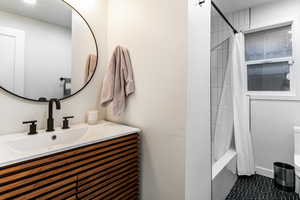 Bathroom with vanity and shower / bath combo