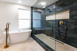 Bathroom featuring plus walk in shower and tile patterned floors