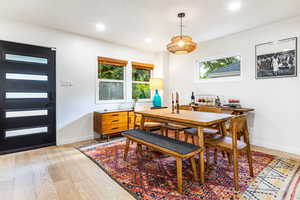 Dining room with light wood-type flooring and plenty of natural light