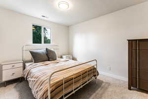 Carpeted bedroom with a textured ceiling