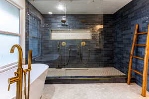 Bathroom featuring separate shower and tub