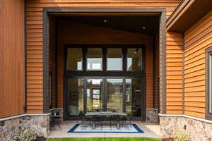 Doorway to property featuring french doors and a patio