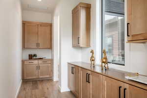 Kitchen with light hardwood / wood-style flooring and plenty of natural light