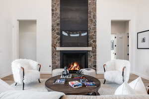 Living room with a large fireplace and wood-type flooring