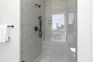 Bathroom featuring a shower with door