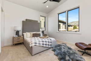 Carpeted bedroom with lofted ceiling and ceiling fan