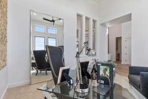 Carpeted dining area with ceiling fan