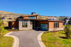 View of front of home featuring a garage and a mountain view