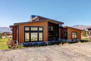 Rear view of property featuring a mountain view