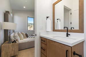 Bathroom featuring vanity and vaulted ceiling