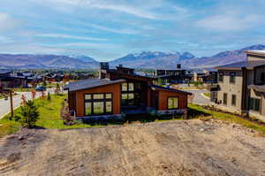 Back of property with a mountain view