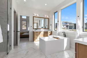 Bathroom featuring vanity and plus walk in shower