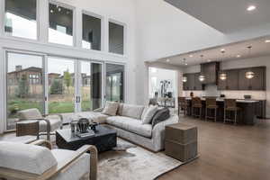 Living room featuring a towering ceiling and hardwood / wood-style flooring