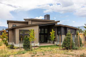 Back of property with a mountain view