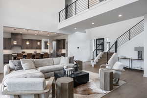 Living room with a high ceiling and hardwood / wood-style flooring