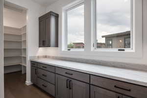 Interior space with light stone counters and dark hardwood / wood-style floors