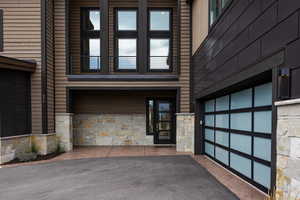 Doorway to property featuring a garage