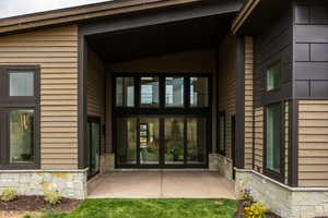 Doorway to property featuring a patio