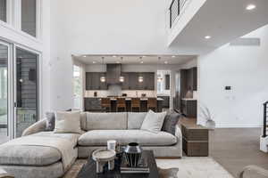 Living room featuring hardwood / wood-style flooring and a high ceiling