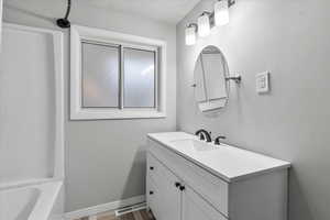 Full bathroom with a sink, toilet and tub.