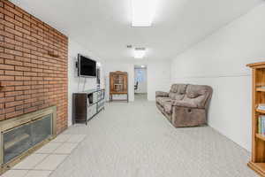 Living room with wood burning fireplace.  New carpet installed on 9/18