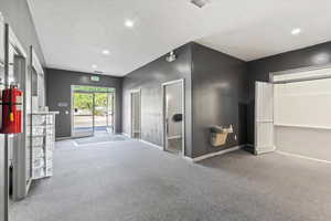 View of building entry from lobby, water fountain and entry to Room 1