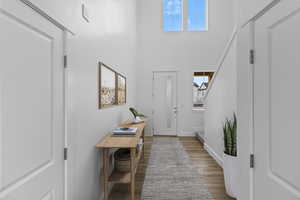 Entryway with light hardwood / wood-style floors and a high ceiling