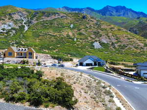 Aerial view of property and surrounding area featuring a mountainous background