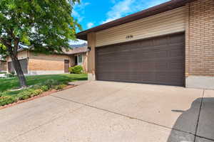 View of front of home with a garage and a front yard