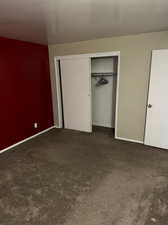 Unfurnished bedroom with carpet flooring and a closet