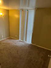 Spare room featuring carpet flooring