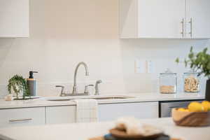 Kitchen with white cabinets and sink