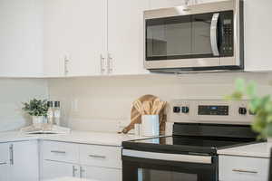 Kitchen with white cabinets and stainless steel appliances