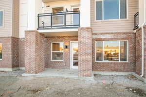 View of exterior entry featuring a balcony