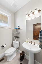 Bathroom with toilet and tile patterned flooring