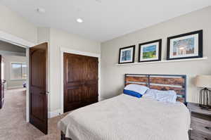 Carpeted bedroom with a closet