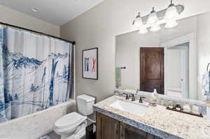 Full bathroom featuring shower / bathtub combination with curtain, tile patterned flooring, toilet, and vanity