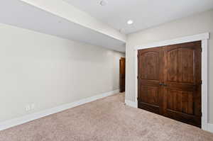 Unfurnished bedroom featuring carpet and a closet