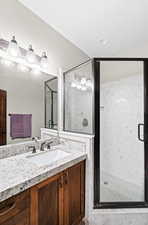 Bathroom with a shower with door and vanity