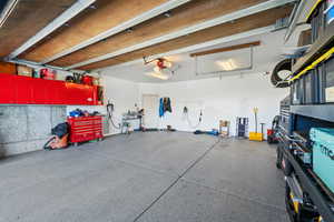 Garage featuring a workshop area and a garage door opener