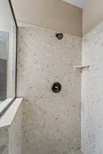 Room details featuring a tile shower