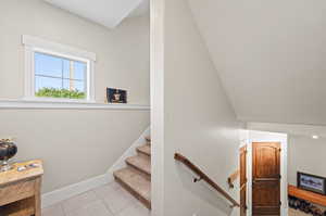 Staircase featuring tile patterned floors