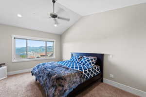 Bedroom with carpet flooring, vaulted ceiling, a mountain view, and ceiling fan