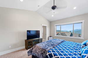 Bedroom featuring lofted ceiling, ceiling fan, and carpet floors