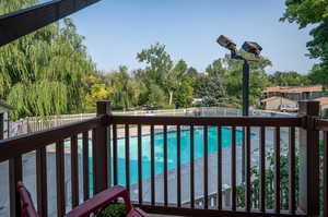 View of swimming pool from this unit's balcony