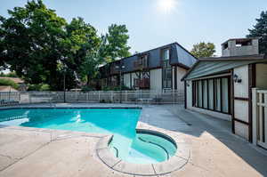 View of swimming pool with nook with seating area and a  large patio area