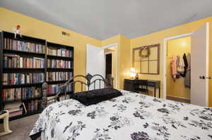 Carpeted  Primary bedroom with a walk in closet