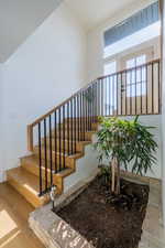 Staircase featuring hardwood / wood-style flooring