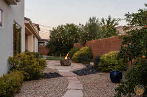 Yard at dusk featuring a patio area