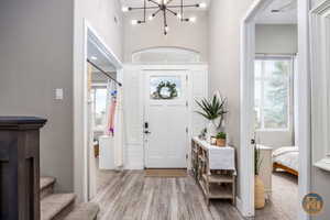 Entrance foyer featuring light wood-type flooring and a chandelier